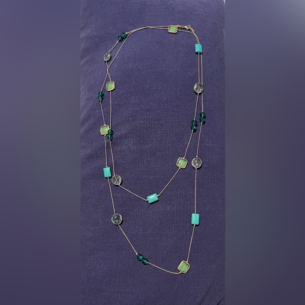 Long chain necklace with gold and green accents